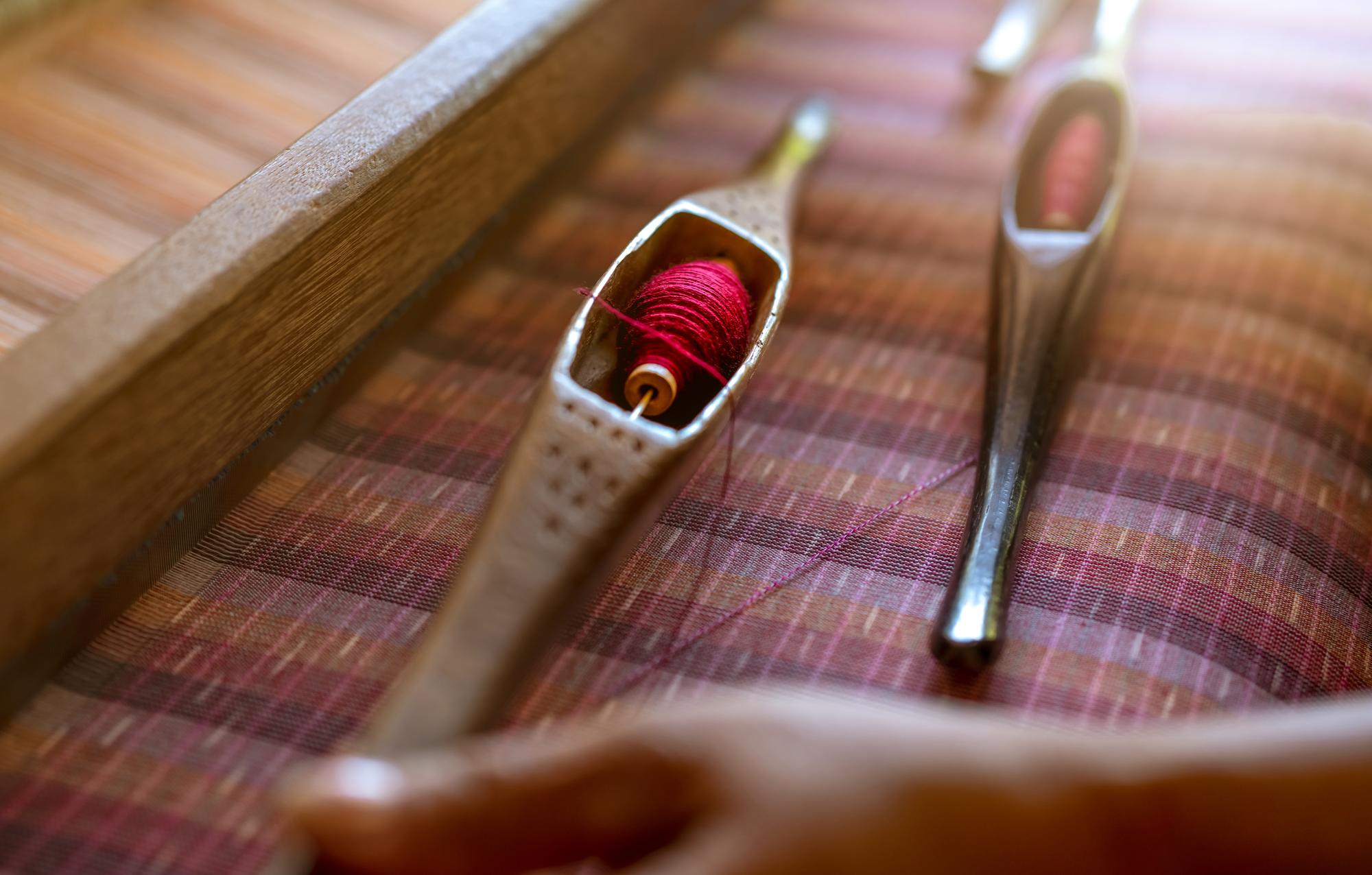 close-up of needle and thread on linen